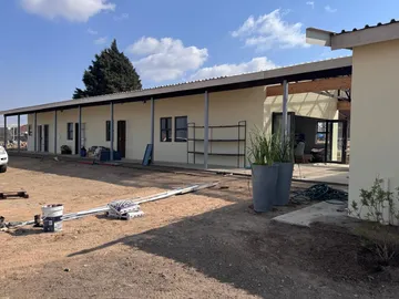 The front facade of the new building, with a covered walkway running along the classrooms.