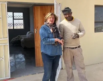 Megan Mackenzie and one of the builders standing at the open door of the new building.